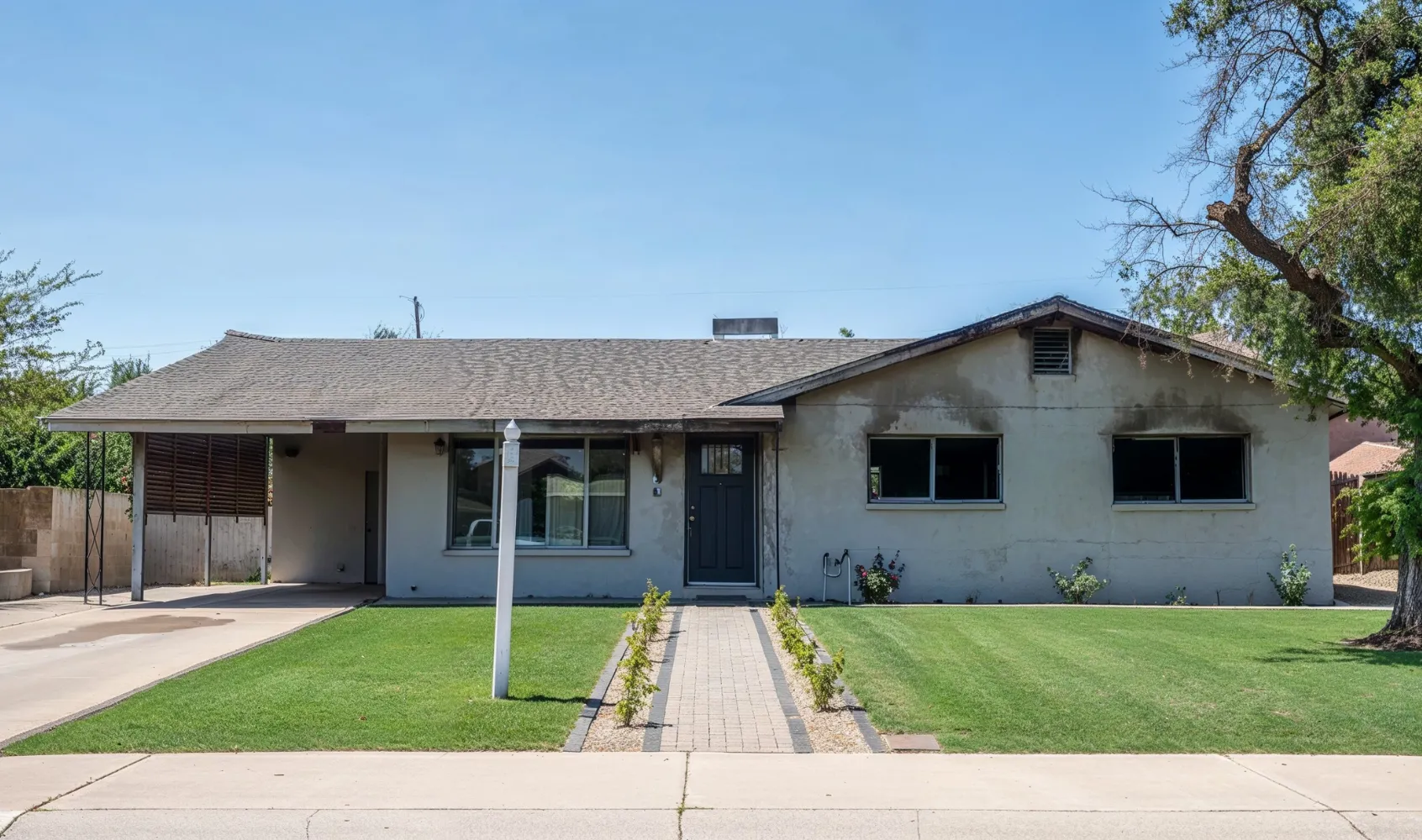 Fire damaged house in Los Angeles showing burned exterior, smoke damage, and structural deterioration before restoration