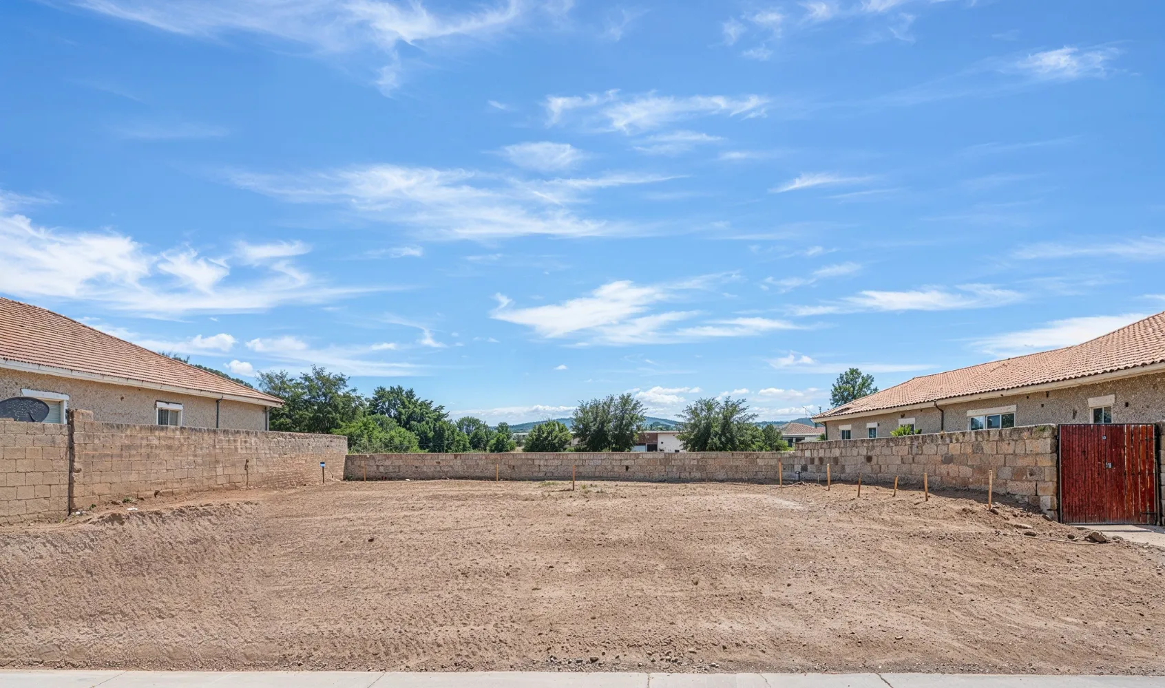 Empty residential lot in Los Angeles prepared for new home construction with cleared land and grading completed