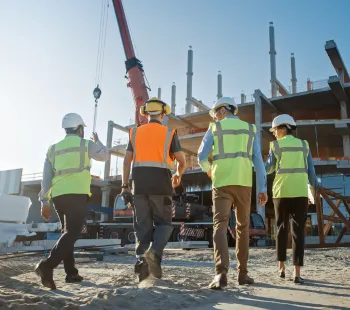 Commercial construction project in Los Angeles showing wood framing structure of new building under development with contractor supervision