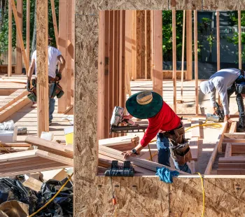 General contractor in Los Angeles managing construction team on active jobsite with crew coordinating large scale building project