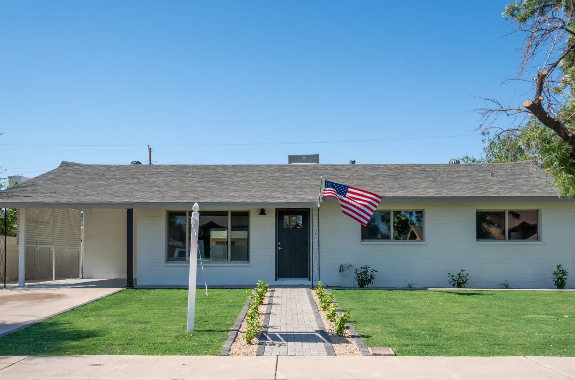 Fire rebuild and restoration project in Los Angeles showing fully restored single story home with new exterior finish and front yard