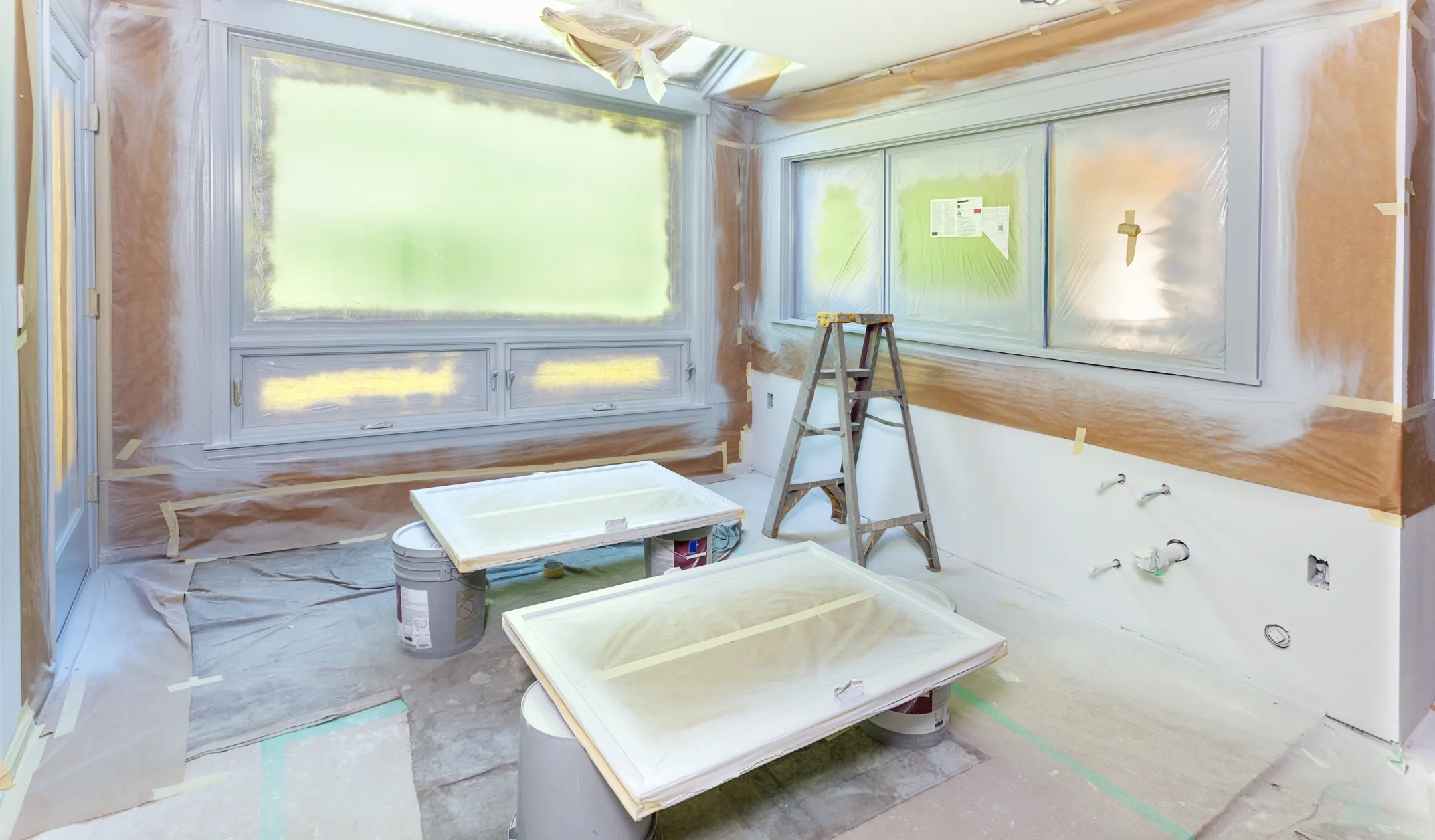 Home remodeling project in Los Angeles with interior renovation preparation including painting setup and protected surfaces before finishing
