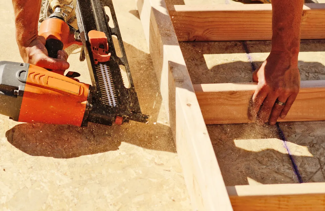 ADU construction in Los Angeles showing framing process with construction worker building new backyard unit structure