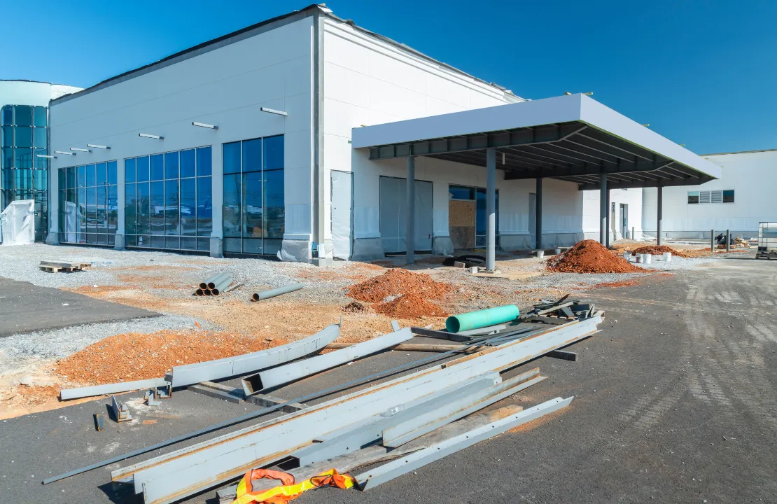 Commercial construction site in Los Angeles with modern building exterior and development crew
