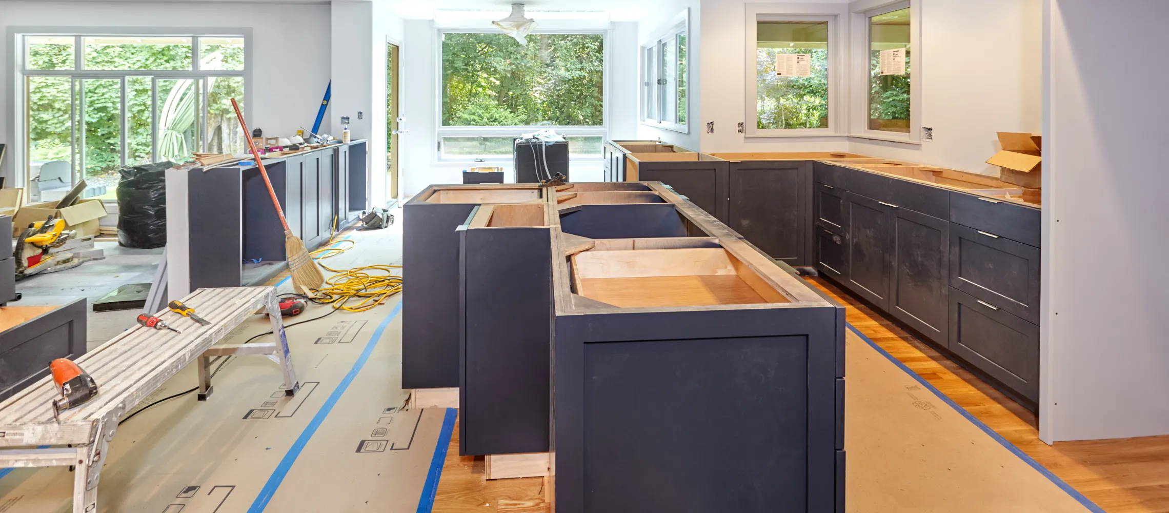 Kitchen remodeling site in Los Angeles with modern cabinet installation and layout renovation in progress with construction crew