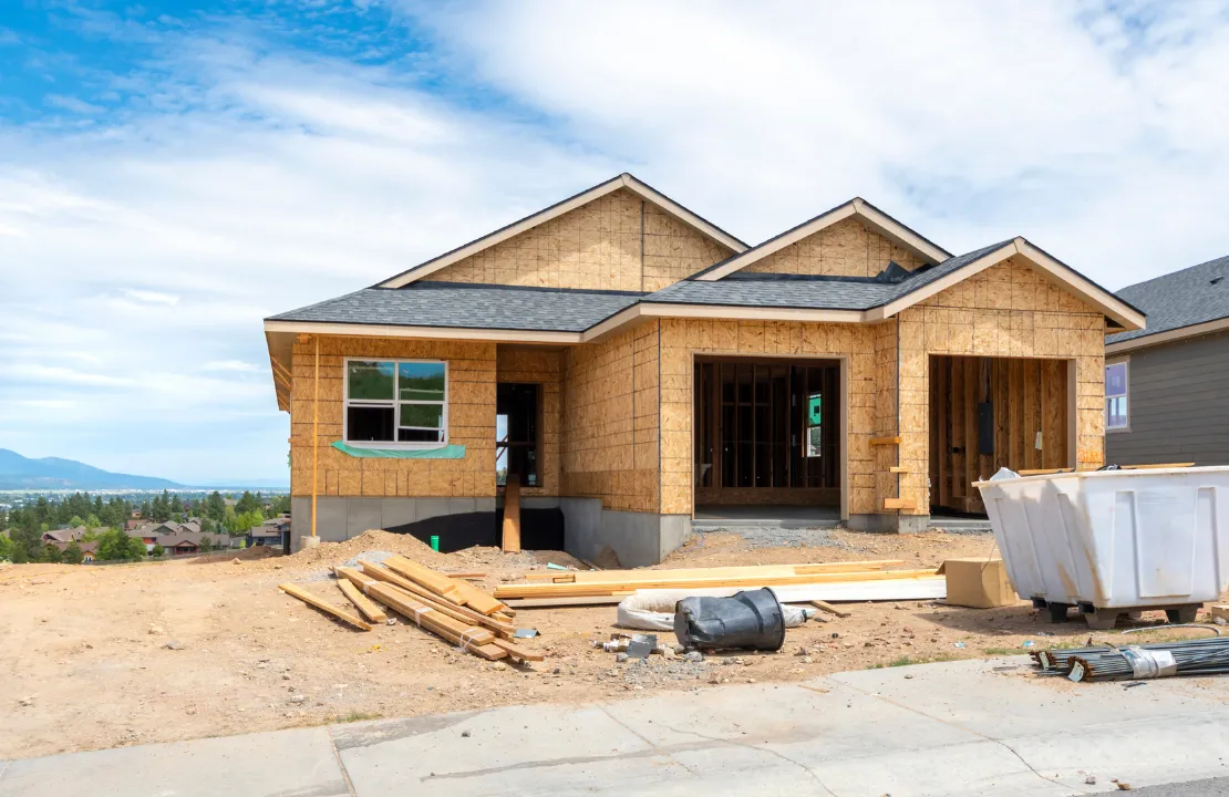 New home construction site in Los Angeles with single-family house framing stage and development crew
